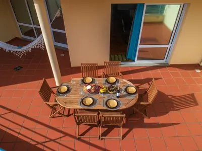 an overhead view of a wooden table with chairs at Apartamento Serramar , Vistas deslumbrantes in Calheta