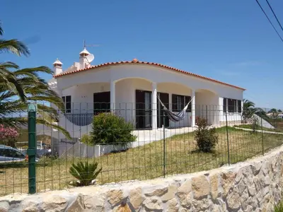 a white house with a fence in front of it at Villa Bartoni in Aljezur