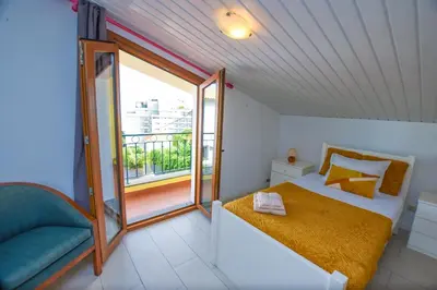 a small bedroom with a bed and a balcony at House near CR7 Museum in Funchal