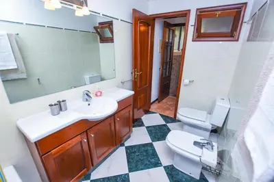 a bathroom with a sink and a toilet and a mirror at House near CR7 Museum in Funchal