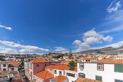 a view of a city with orange roofs at Downtown Funchal Apartments by An Island Apart in Funchal