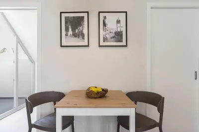 a dining room table with chairs and a bowl of fruit on it at Downtown Funchal Apartments by An Island Apart in Funchal