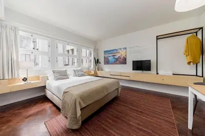 a bedroom with a bed and a flat screen tv at Downtown Funchal Apartments by An Island Apart in Funchal