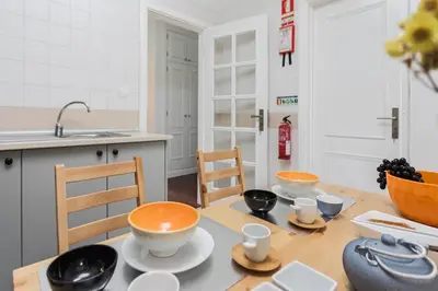 a kitchen with a table with bowls and cups on it at Varandas do Funchal I by An Island Apart in Funchal
