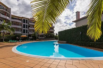 a swimming pool in front of a building at Varandas do Funchal I by An Island Apart in Funchal