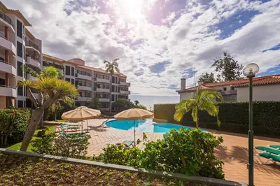 a swimming pool with umbrellas in a resort at Varandas do Funchal I by An Island Apart in Funchal