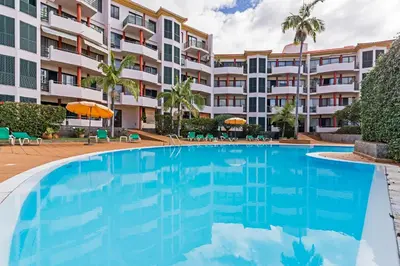 a large swimming pool in front of a building at Varandas do Funchal I by An Island Apart in Funchal