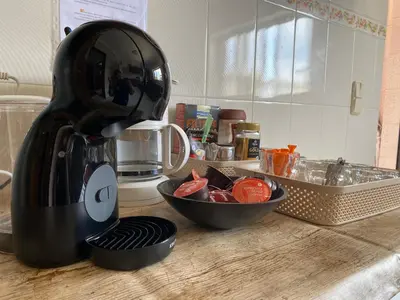 a kitchen counter with a blender and a bowl of fruit at Casa Luana - Rooms in Sagres