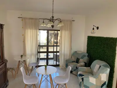 a living room with a couch and a table and chairs at Casa Luana - Rooms in Sagres