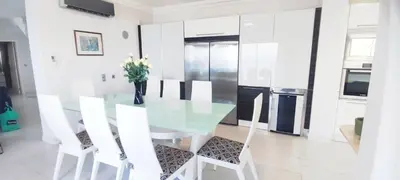 a dining room with a glass table and white chairs at Casa do Mar - Luxurious Villa with Swim Spa & sea view in Luz