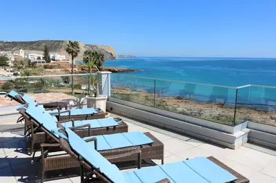 a view of the ocean from the balcony of a resort at Casa do Mar - Luxurious Villa with Swim Spa & sea view in Luz