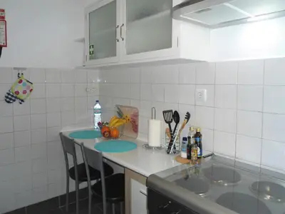 a kitchen with two sinks and a counter top at Terrace Apartment in Funchal