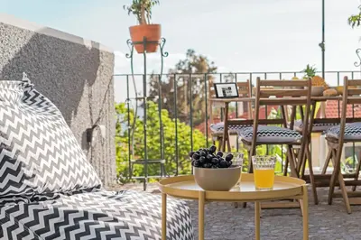 a table with a bowl of fruit on a patio at Arrifes I by An Island Apart in Funchal