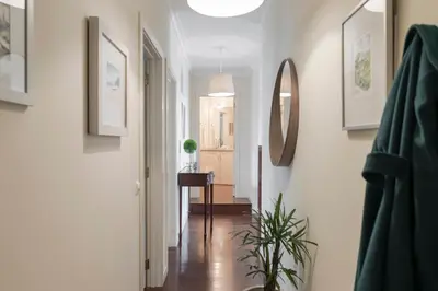 a hallway with white walls and a mirror and a plant at Arrifes I by An Island Apart in Funchal