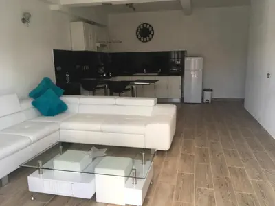 a living room with a white couch and a kitchen at Boa Nova base. in Funchal