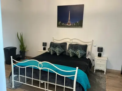 a bedroom with a bed with a picture of the eiffel tower at Boa Nova base. in Funchal