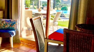 a room with chairs and a table and a patio at Herdade Monte Do Sol in Aljezur