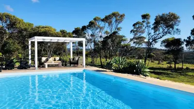 a swimming pool with a gazebo and a house at Herdade Monte Do Sol in Aljezur