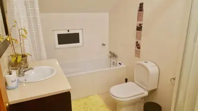 a bathroom with a sink and a toilet and a tub at Pink House in Ponta do Sol