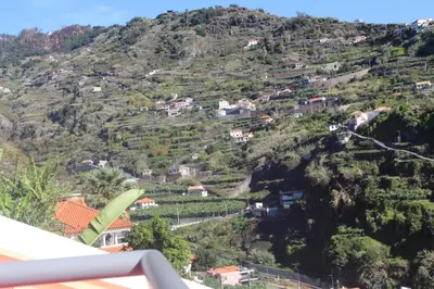 a view of a hill with houses on it at Pink House in Ponta do Sol