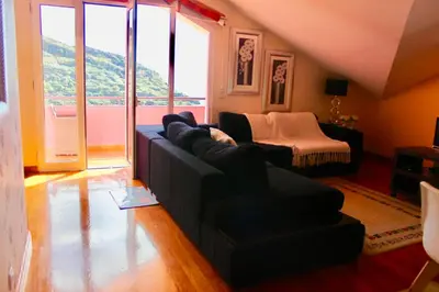a living room with a couch and a table at Pink House in Ponta do Sol