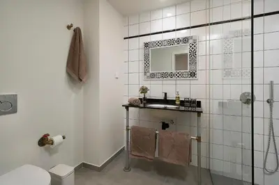 a bathroom with a sink and a mirror at Ivens Residence in Funchal