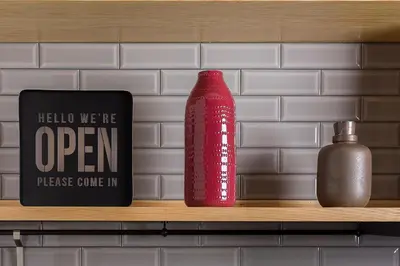 a red bottle and a sign on a shelf at Ivens Residence in Funchal