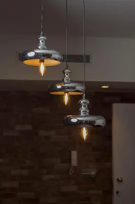 three lights hanging from the ceiling in a room at Ivens Residence in Funchal