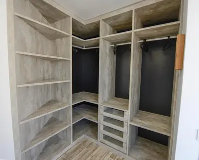 a walk in closet with wooden shelves at Luz Beach Rooftop Penthouse in Luz