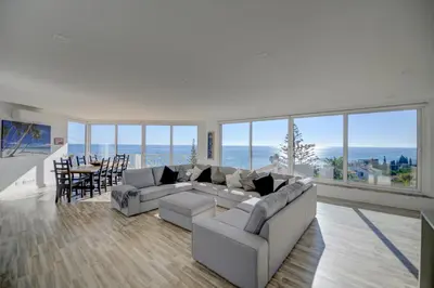 a living room with a couch and a table and chairs at Luz Beach Rooftop Penthouse in Luz