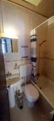 a bathroom with a toilet and a sink and a tub at Cantinho da Avó in Vila do Bispo