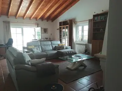 a living room with a couch and a table at Casa Guna in Aljezur