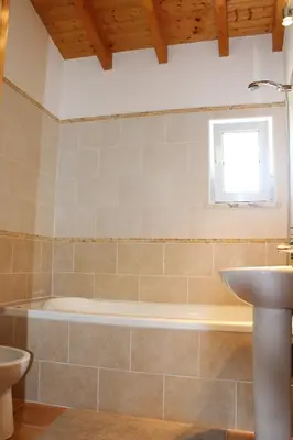 a bathroom with a bath tub and a sink at Casa Guna in Aljezur