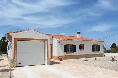a white garage door in front of a house at Casa Guna in Aljezur
