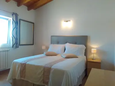 a bedroom with a bed with two pillows on it at Casa Guna in Aljezur