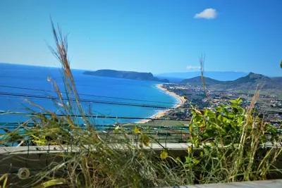 two chairs and a table on a balcony overlooking the ocean at Porto Santo Balcony View House in Porto Santo