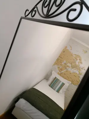 a room with a bed in a box with a map at Travellers Pearl by Storytellers in Funchal