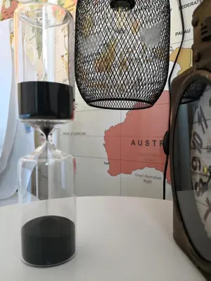 an hourglass sitting on a table next to a toaster at Travellers Pearl by Storytellers in Funchal