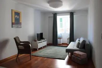 a living room with a couch and a chair at Travellers Pearl by Storytellers in Funchal