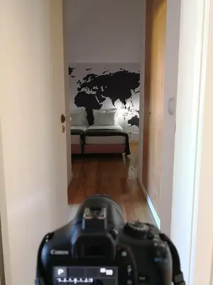 a camera in a hallway with a map on the wall at Travellers Pearl by Storytellers in Funchal