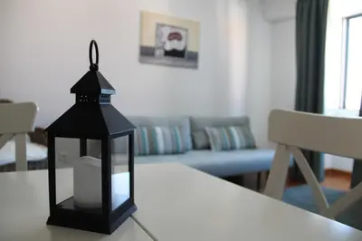 a black lantern sitting on a table in a living room at Travellers Pearl by Storytellers in Funchal