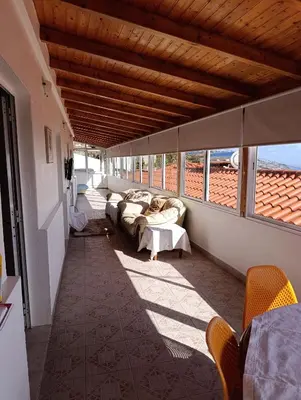 a living room with a couch and chairs on a balcony at The Hill View House in Funchal
