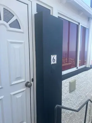 a door in a room with a view of a city at The Hill View House in Funchal