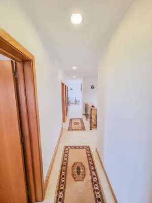 a hallway with rugs on the floor of a house at Loreto Rose, Panoramic Ocean and Mountain View in Arco da Calheta