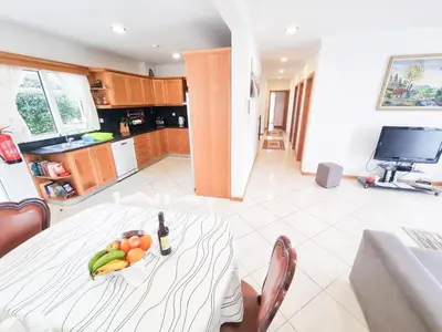a kitchen with a table with a bowl of fruit on it at Loreto Rose, Panoramic Ocean and Mountain View in Arco da Calheta