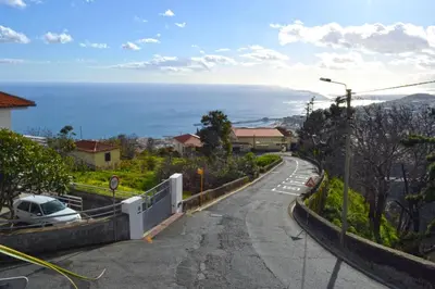 a winding road with a view of the ocean at Bela Vista in Funchal