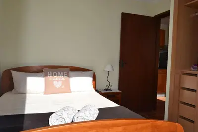 a bedroom with a bed with two shoes on it at Bela Vista in Funchal