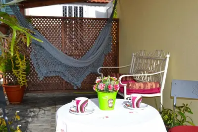 a table with shoes and a potted plant on a patio at Bela Vista in Funchal