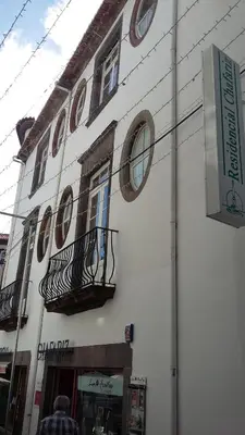 a white building with round windows on the side of it at Residencial Chafariz /Queimada in Funchal