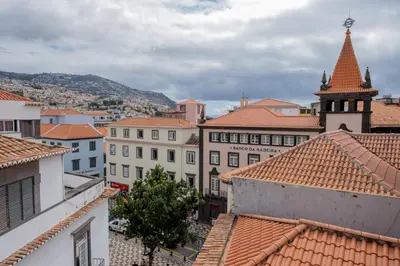 a view of a city with buildings and a tower at Residencial Chafariz /Queimada in Funchal
